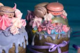 brown and white cake with pink rose on top